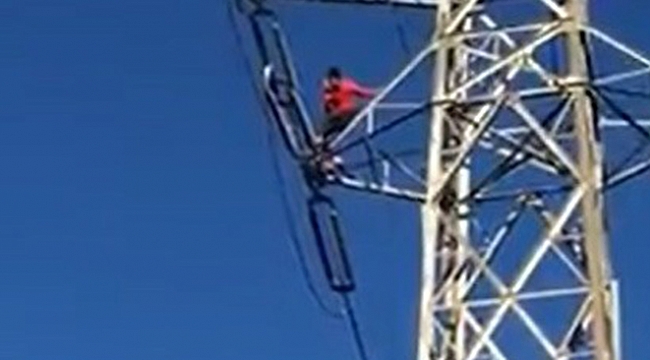 Yüksek gerilim hattı direğine çıkan genç, yürekleri ağza getirdi