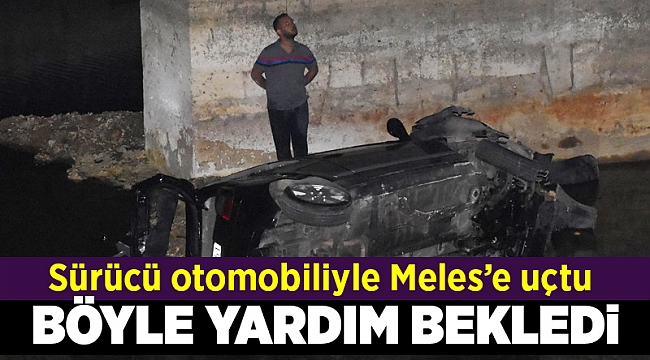 Dereye uçan otomobilinin üzerine çıkıp, yardım gelmesini bekledi